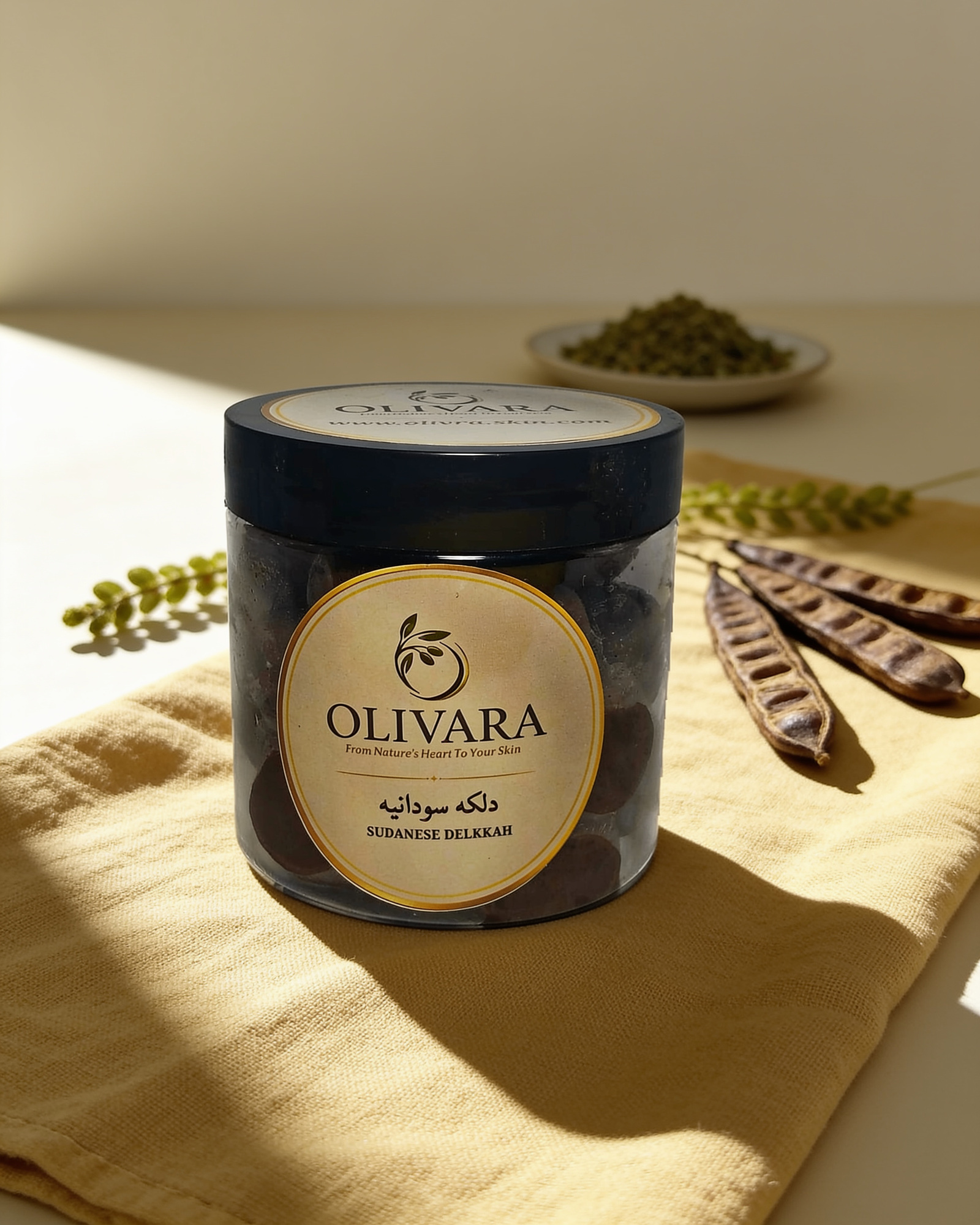 Olivara Sudanese Dalkah jar on linen with acacia pods | برطمان الدلكة السودانية من أوليفارا على كتان مع قرون الأكاسيا